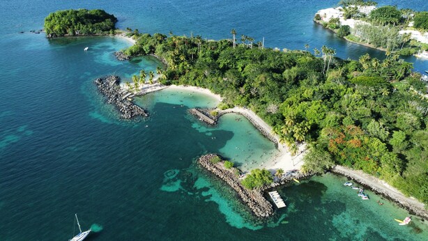 An aerial view of a tropical island with clear waters, a small beach, and a dock with boats. - Studio Zaboka - Beaches & Marina Ideal for couples, many activities on foot! (Les Trois-Îlets)