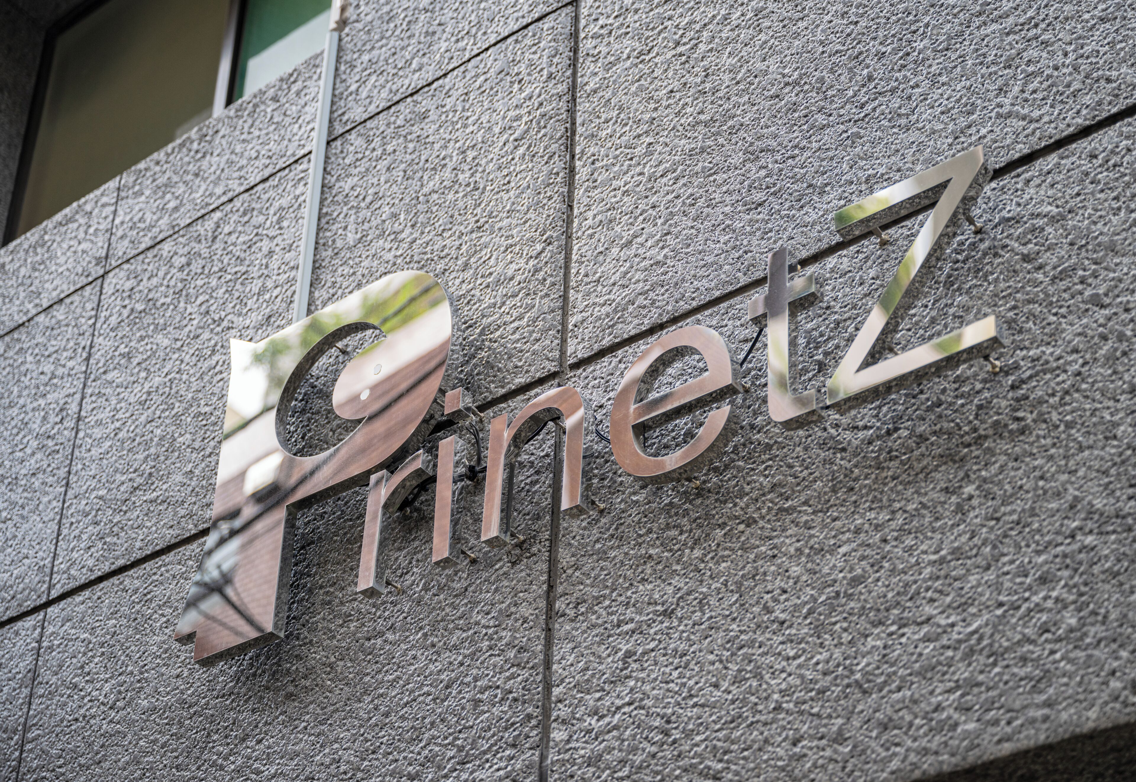 A building facade with the name "Prinetz" in large, metallic letters.