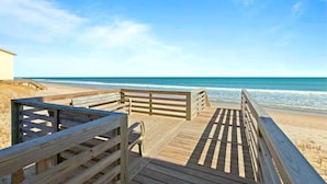 A wooden boardwalk leading to a beach with a clear blue sky. - The Endless Wave: Oceanfront Condo, Sunrise View, Pool, 1-mile to Dining & Pier (Surf City)
