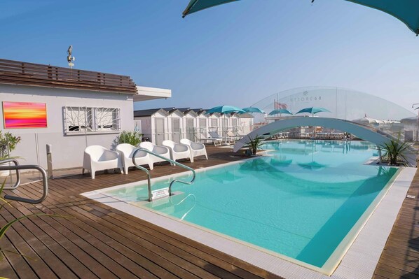 Outdoor pool, open 3:30 PM to 6:30 PM, pool umbrellas, pool loungers