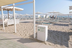 Privatstrand in der Nähe, schwarzer Sandstrand, Liegestühle