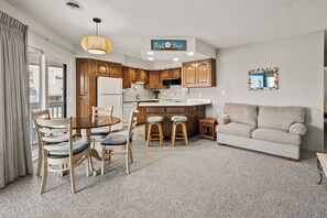 A compact living space with a kitchenette, dining area, and seating area. - Tilghman Lakes B3 (North Myrtle Beach)
