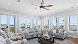 A spacious living room with two grey sofas, a coffee table, and a patterned rug. - Dreams Float, Private Heated Pool/Hot Tub, Pier (Jamaica Beach)