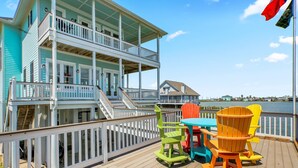 A multi-story building with a balcony and a view of the water. - Dreams Float, Private Heated Pool/Hot Tub, Pier (Jamaica Beach)