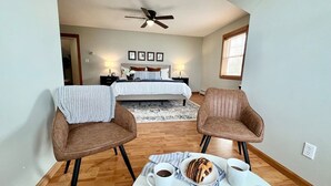 A bedroom with a bed, a ceiling fan, and a nightstand with a lamp. - 5BR Sandy Pond MAIN LAKE HOUSE | Dock | Fire Pit | Pets (Sandy Creek)