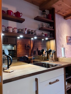 Fridge, stovetop, dishwasher, coffee/tea maker