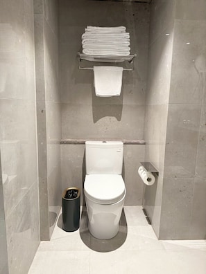 Deluxe Quadruple Room, City View | Bathroom | Shower, hair dryer, slippers, towels