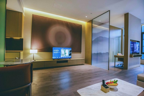 A modern hotel room with a flat-screen TV, a dining table, and a sofa. - Steigenberger Hongqiao Shanghai (Shanghai)