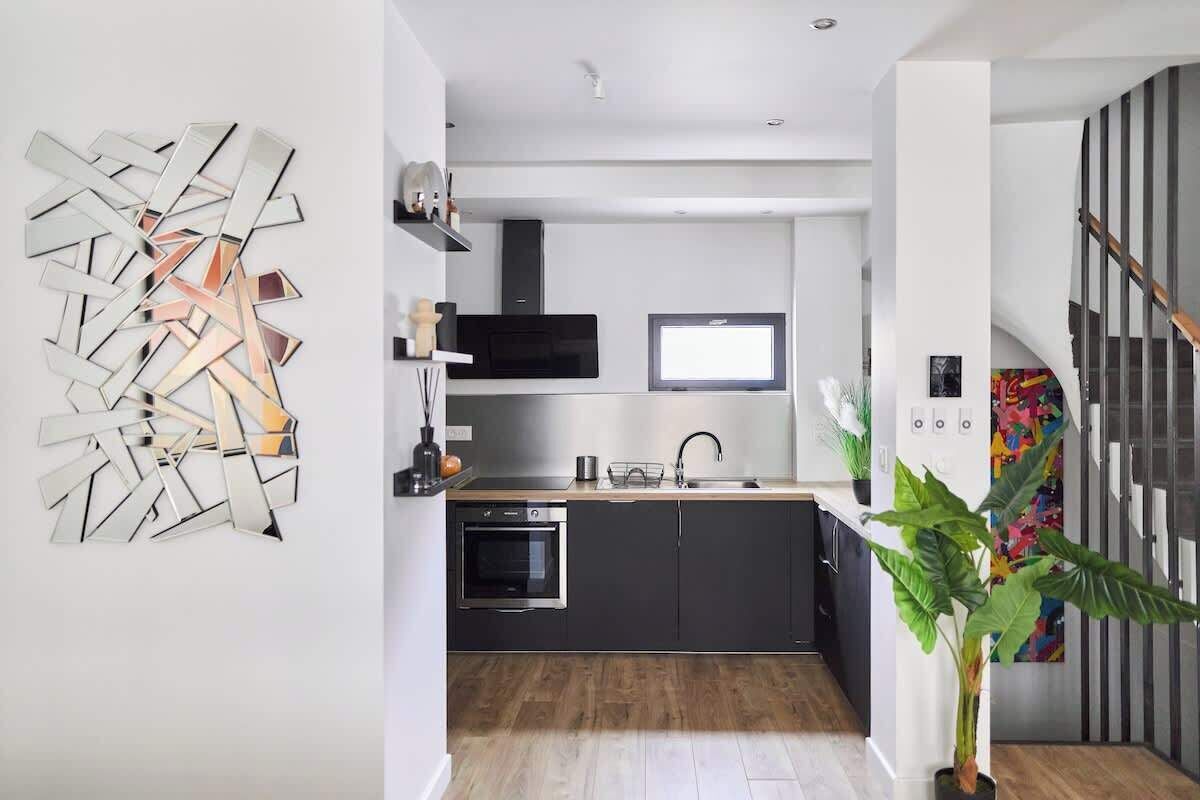 A modern kitchen with a built-in oven, a microwave, and a sink.
