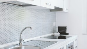 A modern kitchen with white cabinets, stainless steel appliances, and a patterned backsplash. - AlCastellino  holidy home Rapallo (Rapallo)