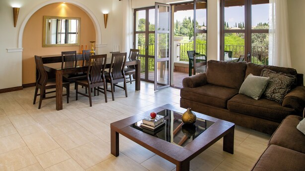 A spacious living area with a dining table, chairs, a sofa, and a coffee table. - 2 Bedroom Apartment - AHB11 (KOUKLIA)
