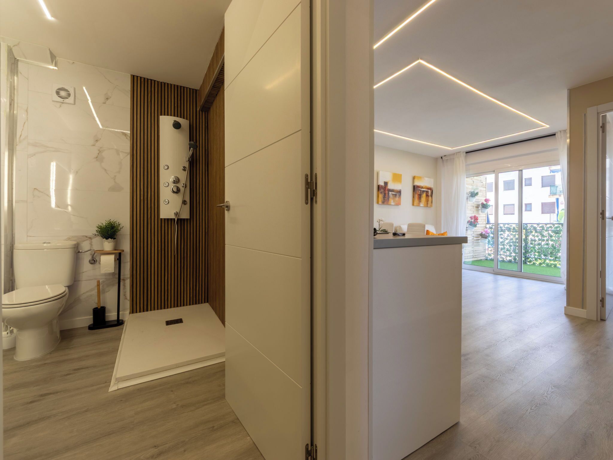 Un bagno moderno con il water, doccia e mobile lavabo.