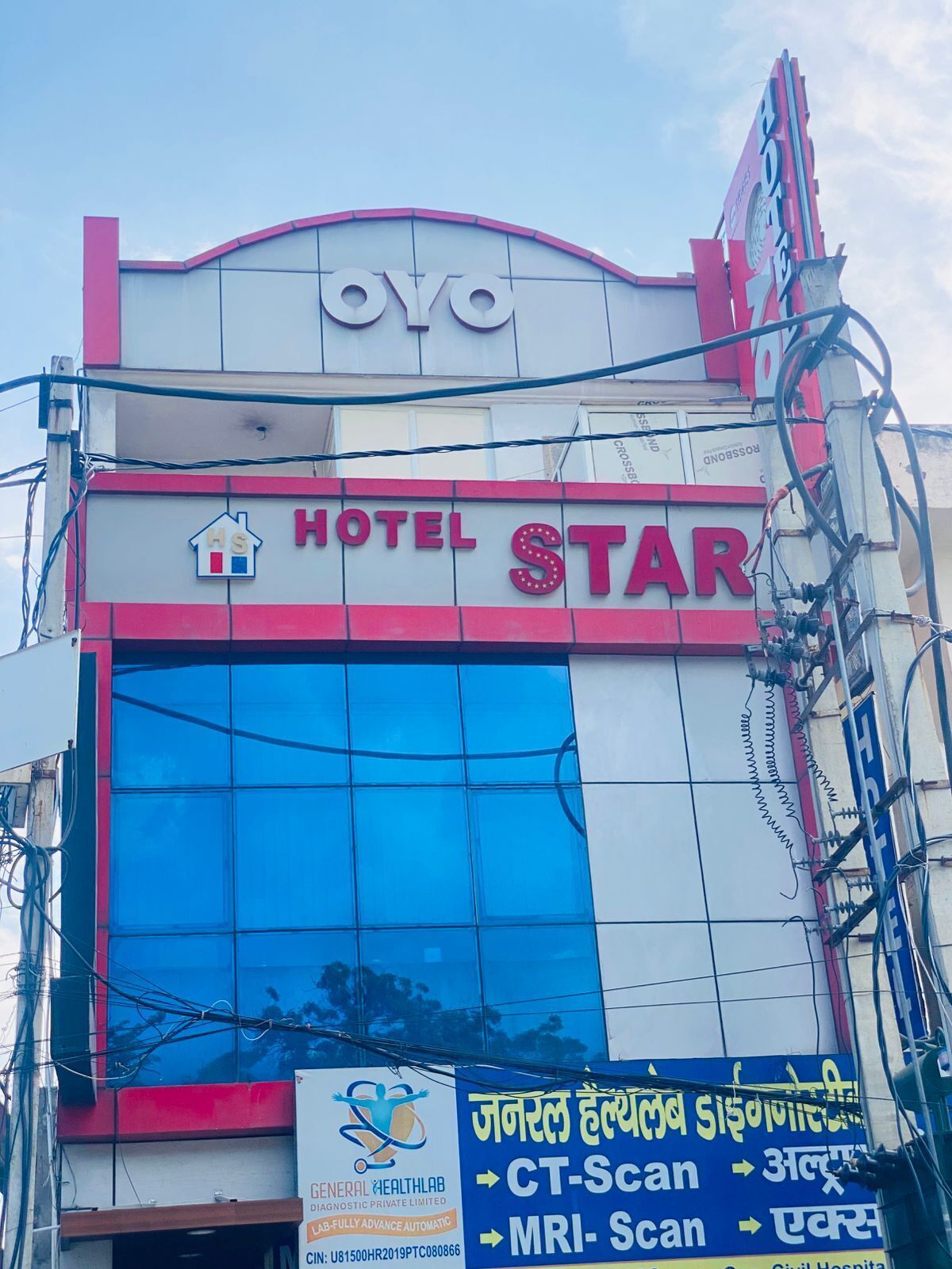 A building with a sign for 'HOTEL STAR' and a medical facility sign below it.
