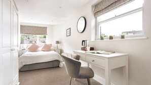 A bedroom with a bed, bedside table, lamp, desk, chair, window with curtains, and a view of the outside. - Kelsick Villa Guest House - Great Gable (Ambleside)