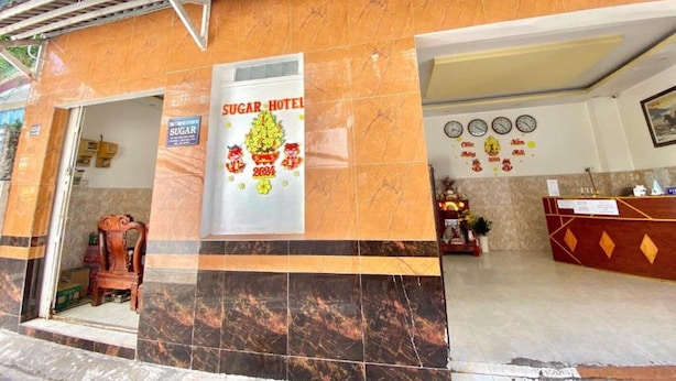 A hotel entrance with a sign reading "SUGAR HOTEL 2024". - Sugar Motel (Can Tho)