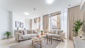 A modern living room with two sofas, a coffee table, and a small side table.