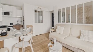 Un espacio habitable moderno y minimalista con cocina, comedor y una zona de estar acogedora.