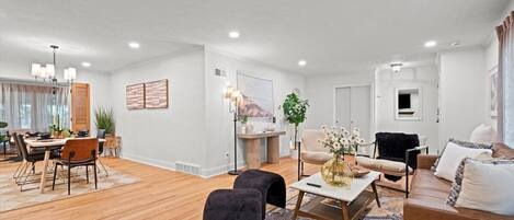 Open-concept living and dining layout offering seamless flow between spaces. One of three seating areas in this large 5-bedroom home built for group stays and easy connection.