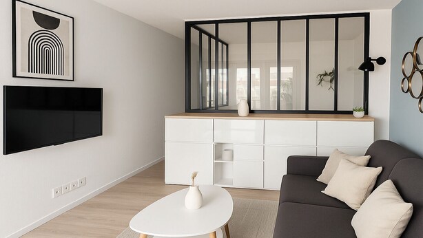 A modern living room with a flat-screen TV, a white coffee table, a dark sofa, and a white cabinet with a wooden countertop. - Charmant T2 lumineux près de Montmartre (Paris)