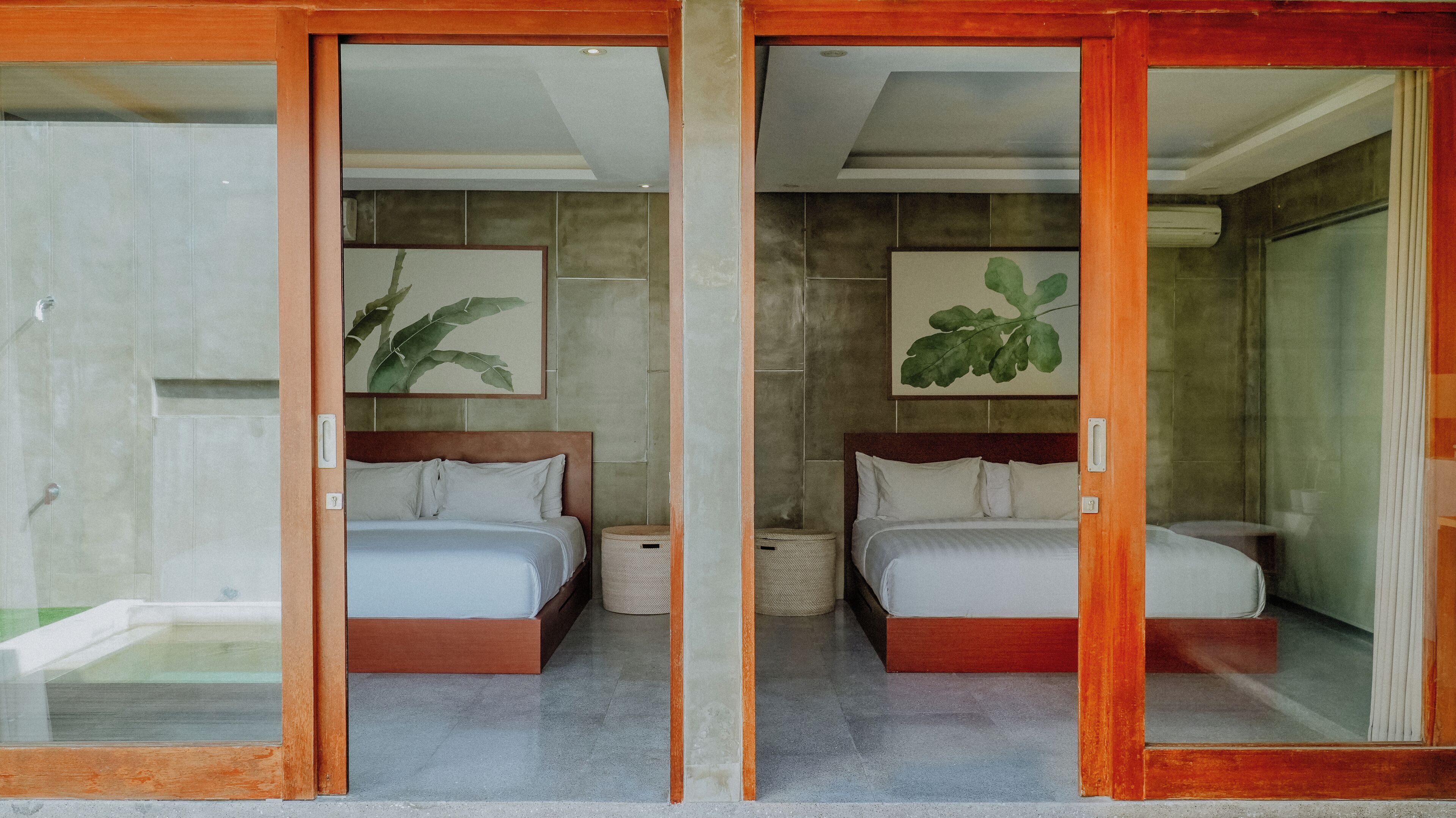 A hotel room with two beds, a large mirror, and a view of the outside.