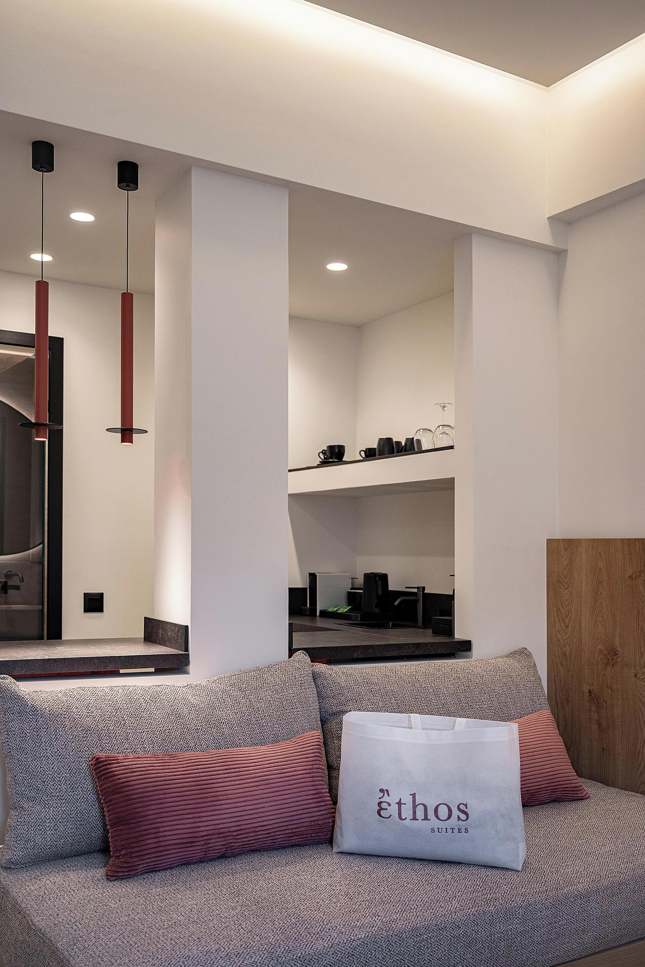 A modern interior with a sofa set, a coffee machine, and a mirror.