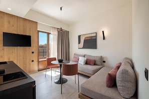 Deluxe Suite, 1 Bedroom | Living area | 40-inch Smart TV with cable channels