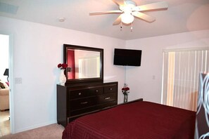 A bedroom with a bed, dresser, TV, and ceiling fan. - The Beauty of Solana Near Disney and Universal (Davenport)