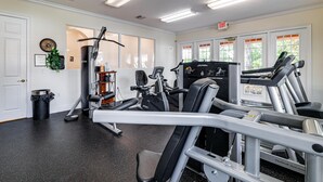 A gym with various exercise equipment, including treadmills and weight machines. - The Beauty of Solana Near Disney and Universal (Davenport)