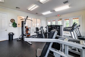 A gym with various exercise equipment, including treadmills and weight machines. - The Beauty of Solana Near Disney and Universal (Davenport)