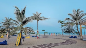 A beach with palm trees, wooden walkways, and surfboards. - Seava Beach (Tha Sala)