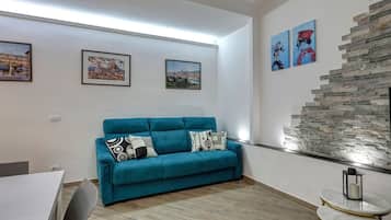 Apartment | Living area | 30-inch flat-screen TV with satellite channels