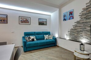 Apartment | Living area | 30-inch flat-screen TV with satellite channels