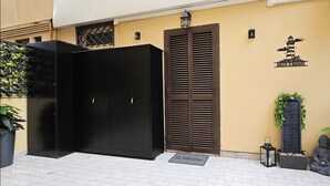 A black wardrobe, a brown door, and a welcome mat outside a building. - Love nest with Jacuzzi and Terrace on the Port of Anzio (Anzio)