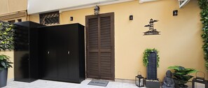 A black wardrobe, a brown door, and a welcome mat outside a building. - Love nest with Jacuzzi and Terrace on the Port of Anzio (Anzio)