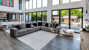 A spacious living room with a large sectional sofa, a pool table, and a bar area. - 5 Bed Villa-sleeps 10-hot Tub-bar & Pool Table (Doncaster)