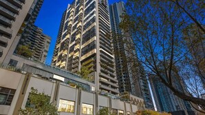 A high-rise building with multiple balconies and a modern architectural design.