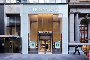 The exterior of a Tiffany & Co. store with large glass windows and a classic architectural facade.