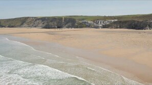 A beach with a building in the background.