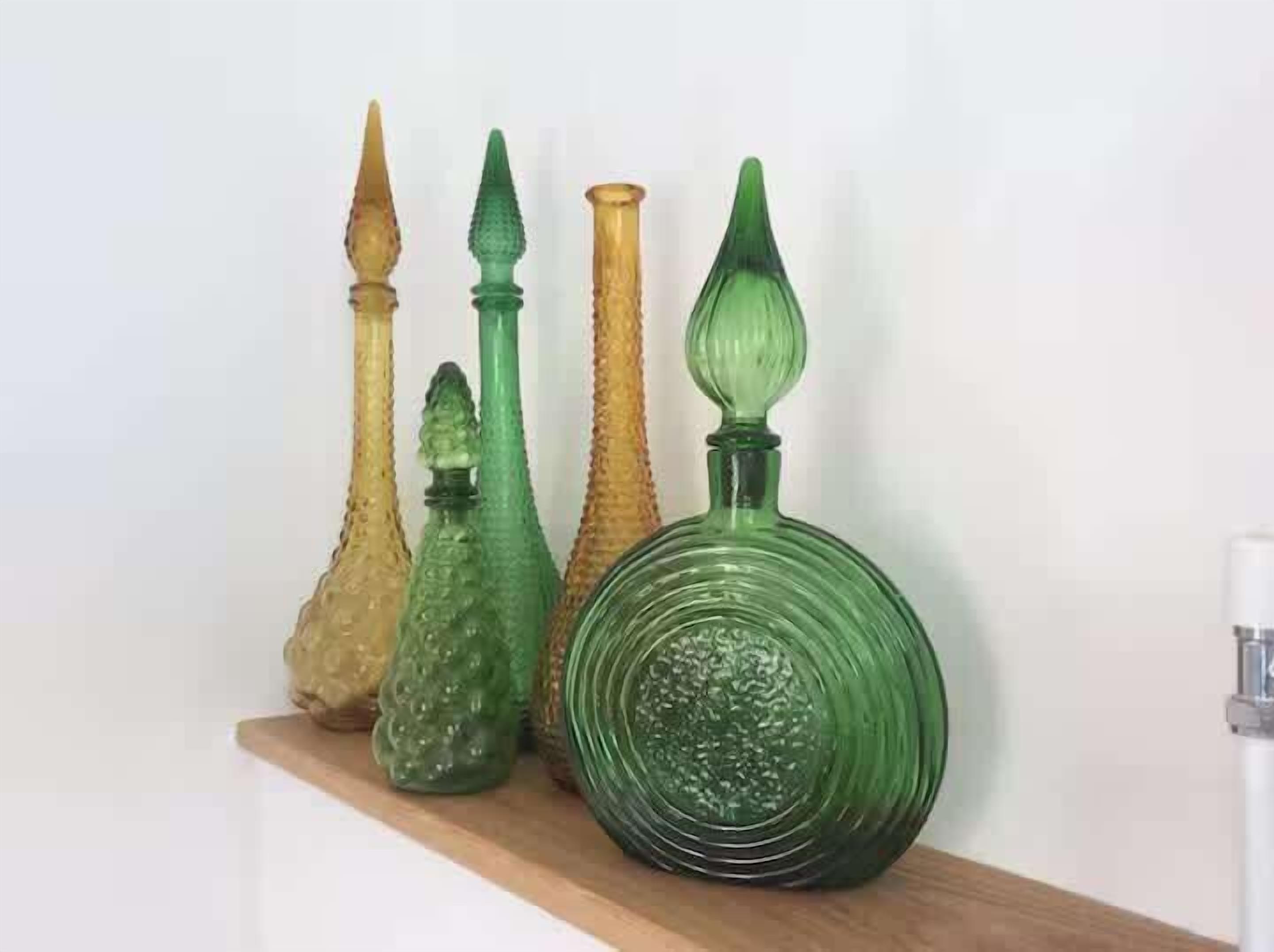 A collection of glass vases on a shelf.