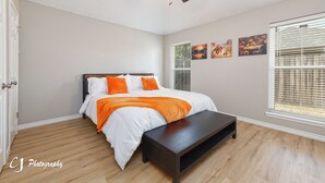 A bedroom with a bed, a bench, a ceiling fan, and artwork on the wall. - Rex Ranch is a comfortable conveniently located 3 bedroom 2 bath home. (Abilene)