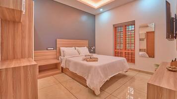 A modern bedroom with a wooden bed, a nightstand, a bedside table, and a TV mounted on the wall.