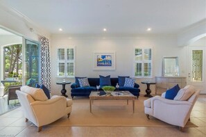 A living room with two sofas, a coffee table, and a painting on the wall.
