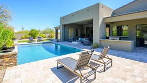 A modern house with a swimming pool, outdoor seating, and a patio area. - Luxury in North Scottsdale sleeps 10 (Scottsdale)