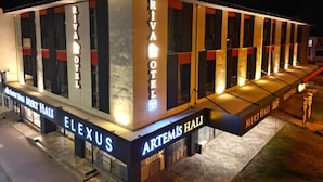 A modern hotel with a prominent 'RIVA HOTEL' sign, multiple entrances, and a covered outdoor area. - Karasu Riva Otel (Karasu)