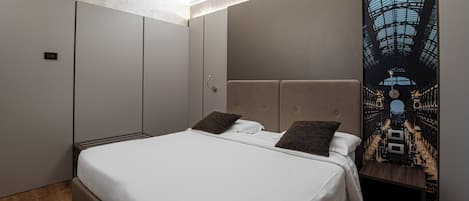 A modern bedroom with a large bed, a headboard with a cityscape mural, and a wooden bench.