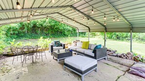 An outdoor patio with a covered seating area, including a table and chairs, and a sofa with cushions. - 4 Mi to Dtwn: Relaxing Escape w/ Yard in Atlanta (Atlanta)