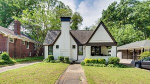 A two-story house with a prominent chimney, a front porch, and a well-maintained lawn. - 4 Mi to Dtwn: Relaxing Escape w/ Yard in Atlanta (Atlanta)