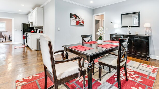 A dining area with a table set for four, surrounded by wooden chairs with cushioned seats. - 4 Mi to Dtwn: Relaxing Escape w/ Yard in Atlanta (Atlanta)
