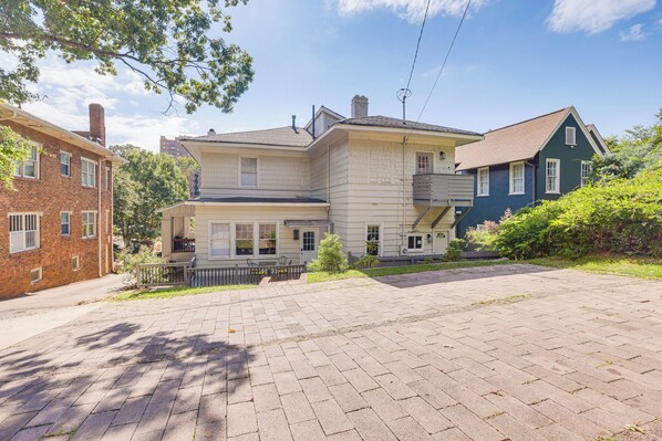 A two-story house with a brick facade, a front porch, and a paved driveway. - 2 Mi to Dtwn: Stylish Urban Retreat in Birmingham (Birmingham)