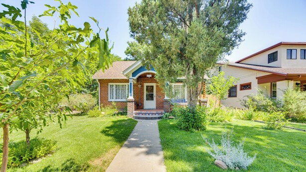 A two-story house with a front porch, a brick facade, and a well-maintained lawn. - 1 Mi to Riverwalk: Home w/ Fenced Yard in Pueblo (Pueblo)